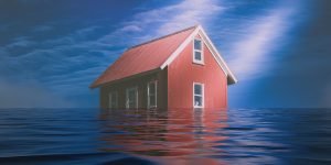 A red house with a sloped roof is partially submerged in deep water, with only the upper part visible. The sky is cloudy with a mix of blue and grey tones, making you wonder, should you buy a flood-risk property?