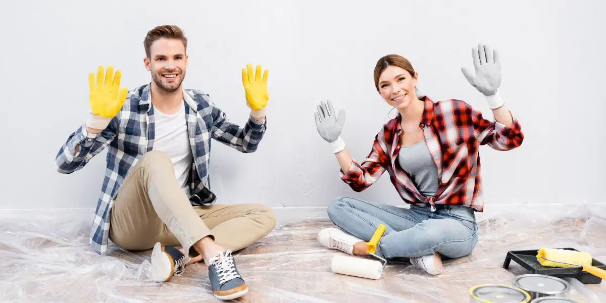 couple painting a property
